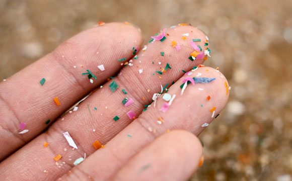 Microplastic - Small bits of plastic on fingers